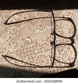 Shadow Of Progressive Lens Black Frame Glasses On Patterned Tablecloth