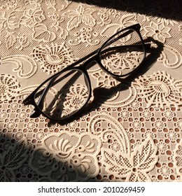 Shadow Of Progressive Lens Black Frame Glasses On Patterned Tablecloth