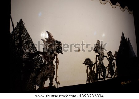 Shadow puppet figures on back light screen. The cultural heritage of traditional performing arts which is popular among Javanese.