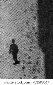 Shadow Of Senior Man On Cobble Stone In Lisbon