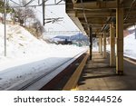 Shadow and snow covered train platform early morning with lonely station, Hokkaido, Japan