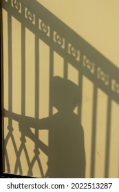 The Shadow Of Someone Locked Behind Bars And Wishing For Freedom