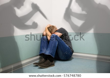 Shadow Of Two People Attacking Abuse Man Sitting At The Corner Of A Room
