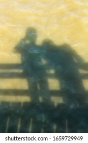 The shadow two persons on the surface water sea