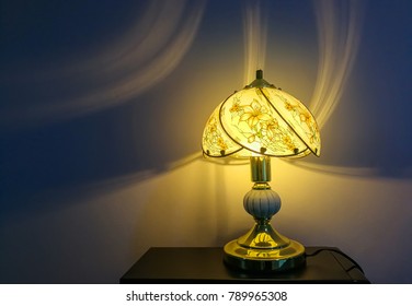 Shadow And Warm Light Pattern On Wall Texture From Electric Light Lamp On Table. Abstract  Light And Dark Blue Shadow Background
