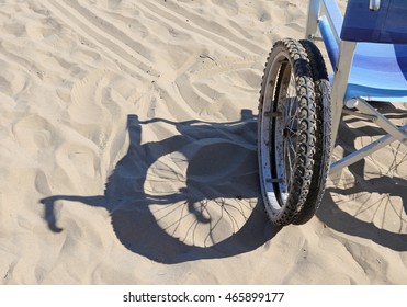 Shadow Of A Wheelchair On The Sand