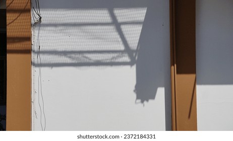 Shadow of a window on a white wall. Horizontal photo.Space using put text or document