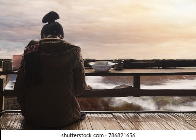 The Shadow Of A Woman Sitting On Her Back On The Balcony Alone To Wait For Her Lover Back.
Sky Background In The Bright Morning Of Winter At Sunrise On The Horizon Above The Mountain.