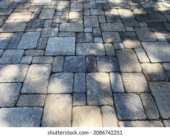 A Shadows Cast Over Large Thick Stone Cobblestone Driveway Path