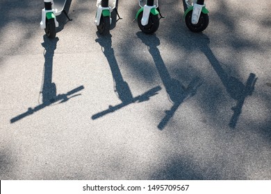 shadows of E-Scooter on asphalt pavement