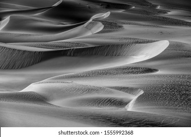shadows and light in the desert in black and white, beautiful monochrome landscape of the endless sand dunes 