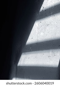 Shadows and light through the gaps in the windows on the wall