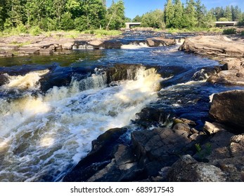 Shadows on the Rushing Water in Big Falls on a Summer Day