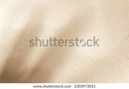 Shadows and patterns on the sand of dune. Sandy beach for the background. Sand texture. Background, sand, light, beige, wave, reflect, shadow, summer. Summer concept.