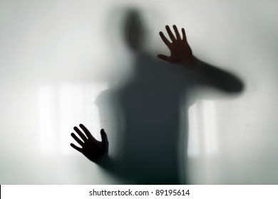Shadowy figure behind glass - Shutterstock ID 89195614