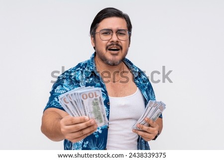 A shady and unscrupulous middle aged man in an unbuttoned Hawaiian shirt offering cash for an illicit offer. Isolated on a white background. Foto d'archivio © 