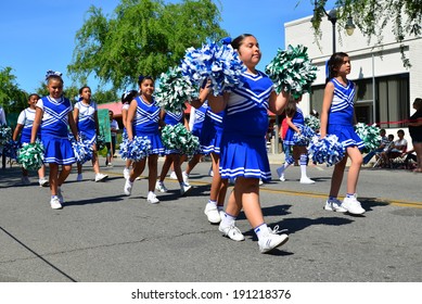 SHAFTER, CA - MAY 3, 2014: These Little Girls, Members Of The Redwood School's Pep Squad, Are Having A Good Time Marching In The Cinco De Mayo Celebration Parade. 