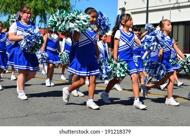 SHAFTER, CA - MAY 3, 2014: These Little Girls, Members Of The Redwood School's Pep Squad, Are Having A Good Time Marching In The Cinco De Mayo Celebration Parade. 