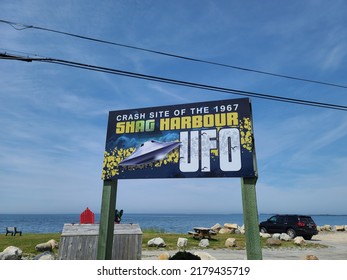 Shag Harbour NS, CAN, July 16th, 2022 - A large sign indicating the crash site of the UFO in Shag Harbour during 1967 sitting under a cloudy sky.