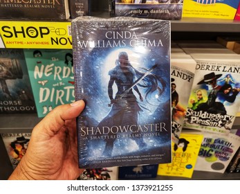 Shah Alam, Malaysia - 14 April 2019 : Hand hold a SHADOWCASTER by CINDA WILLIAMS CHIMA book for sell in the book stores with selective focus.