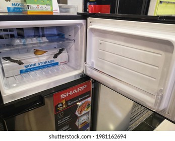Shah Alam, Malaysia - 22 May 2021 : Empty modern fridge with open doors at freezer and storage display for sell in the shopping mall with selective focus.

