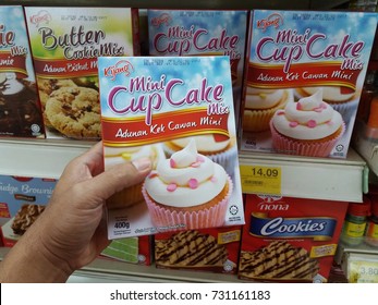 Shah Alam , Malaysia - 7th October 2017 : Hand Pick Up A Packed Box Of Mini Cup Cake Mix Flour In Supermarket