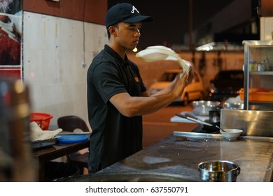 SHAH ALAM, MALAYSIA - MAY 10 2017: A Young Boy Is Making Roti Canai