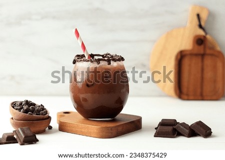 Shake Iced Chocolate with Creamy Choco Sauce, Served on Clear Glass on White Table. Copy Space for Text 
