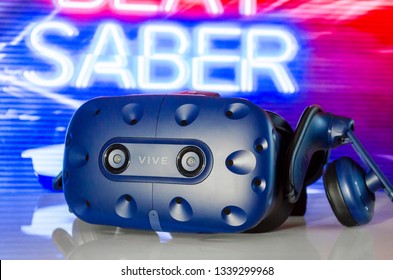 SHAKHTERSK, RUSSIA - MARCH 15, 2019: A Closeup Of A  Virtual Reality Headset HTC VIVE PRO On The Background Of The Game Beat Saber.