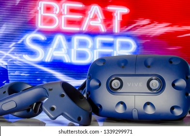 SHAKHTERSK, RUSSIA - MARCH 15, 2019: A Closeup Of A  Virtual Reality Headset HTC VIVE PRO On The Background Of The Game Beat Saber.