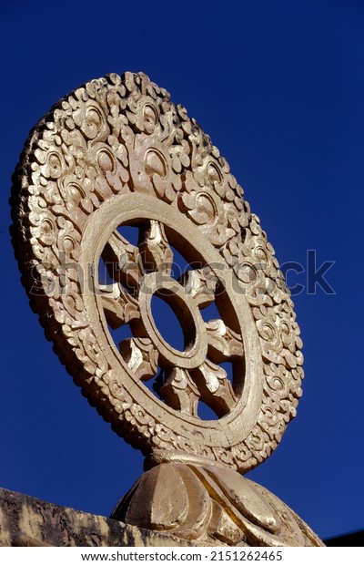 Shakhya Tharig Buddhist Monastery. \
Golden Dharma wheel. Buddhism sacred symbol.\
Dharmachakra.