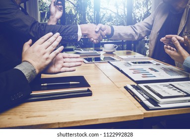 Shaking Hands Of Business Lawyer Of Tax And Real Estate Broker After Meeting In Conference Room, All People Happy Successfully.