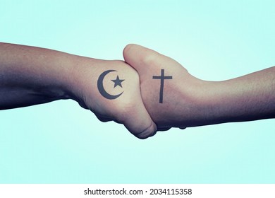 Shaking hands with a Muslim religious symbol and Christian religious symbol. Religious tolerance - Shutterstock ID 2034115358