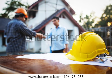 Shaking hands of partnership agreement between structural engineers and contractors to build houses. After agreeing the employment price and calculating the cost of construction and repair real estate