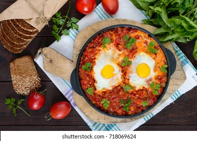 Shakshuka - A Dish Of Eggs Fried In A Sauce Of Tomatoes, Hot Pepper, Onions And Seasonings. Israeli Cuisine. Served For Breakfast With Rye Bread.