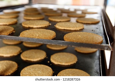 Shallow depth of feild image of Oat Cakes on an commercial baking tray, just after leaving the overn No.1