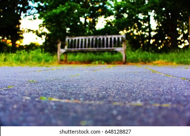 A Shallow Depth Of Field Of A Blurred Wooden Bench 