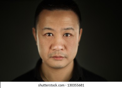 A Shallow Depth Of Field Close Up Portrait Of A Young Asian Man