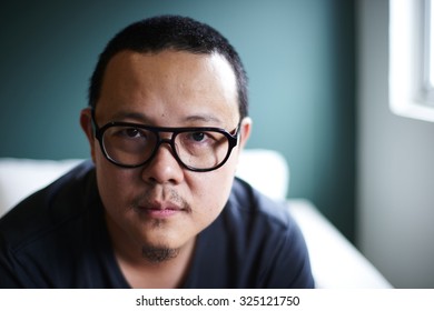 A Shallow Depth Of Field Close Up Portrait Of A Young Asian Man