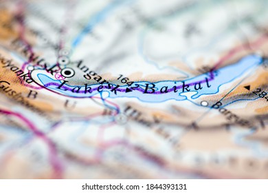 Shallow Depth Of Field Focus On Geographical Map Location Of Lake Baikal Off Inland Of Siberia On Atlas