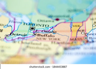 Shallow Depth Of Field Focus On Geographical Map Location Of Lake Ontario Off Inland Of Canada On Atlas