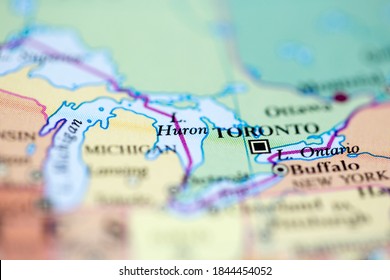 Shallow Depth Of Field Focus On Geographical Map Location Of Lake Huron Off Inland Of Canada On Atlas