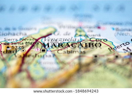 Shallow depth of field focus on geographical map location of Maracaibo city Venezuela South America continent on atlas