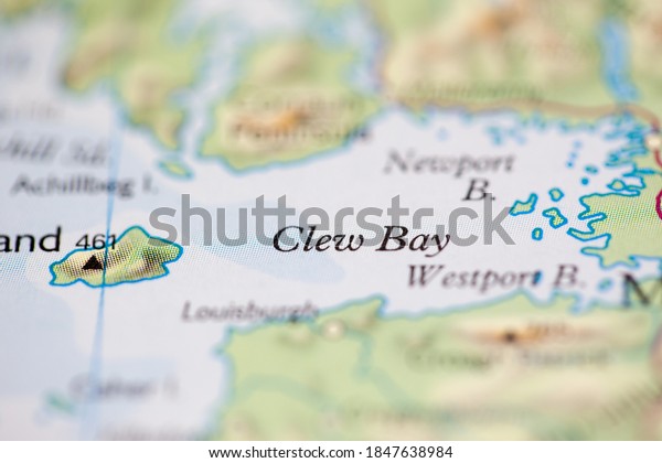 Shallow depth of field focus on\
geographical map location of Clew Bay off coast of Ireland on\
atlas