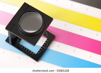 Shallow Depth Of Field Image Of A Printers Loupe On Printed Sheet.  Focus Is On The Top Of The Loupe.