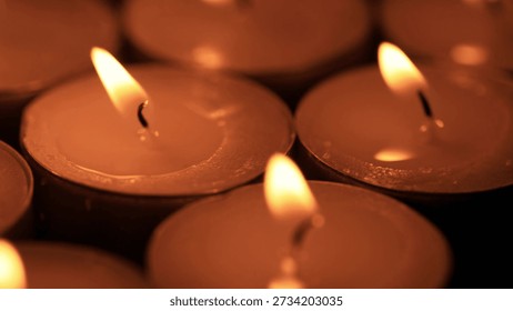 shallow depth of field macro of burning red candles on the rotating stand