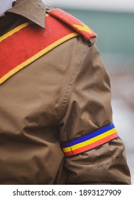 Shallow depth of field (selective focus) with the uniform of a Romanian soldier during an official ceremony on a cold and snowy winter day.