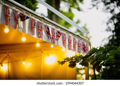 Shallow Depth Of Field (selective Focus) Details With The British Flag And A Merchandise Tent During A British Themed Garden Party.