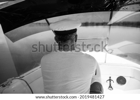 Shallow depth of field (selective focus) image with a small boat driver (captain,skipper).
