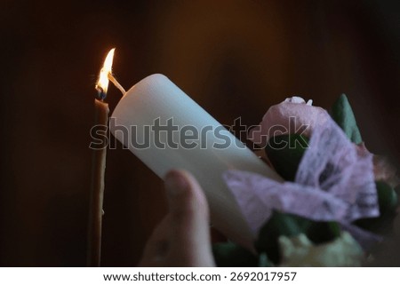 Shallow depth of field (selective focus) details with a candle inside an orthodox church during a baptism.